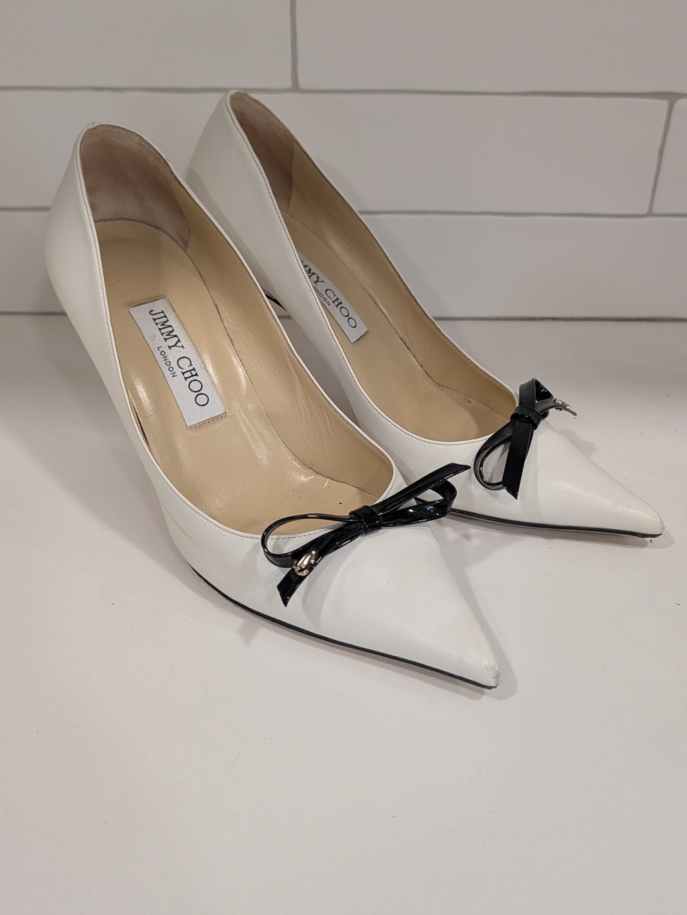 Jimmy Choo White Pointed-Toe Pumps with Black Bow Accent